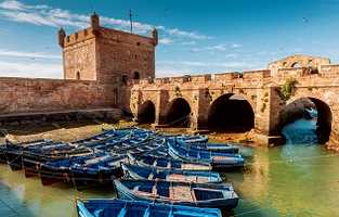 boats on river under a bridge