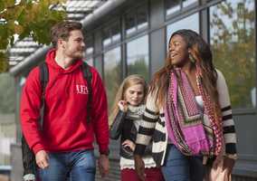 students walking past UEA medical building on campus